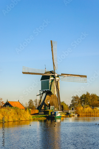 Historic Dutch windmill at the bank of a canal