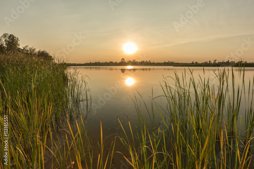 Landscape of calm lake at sunset 