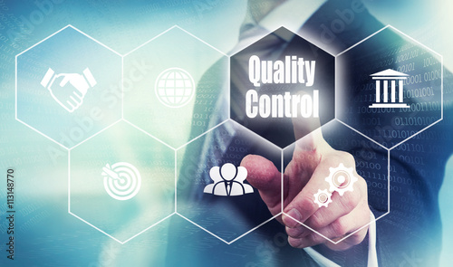 Fotografia Businessman pushing a quality control concept button.