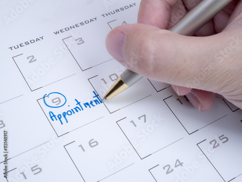 Woman hand write appointment on calendar 1