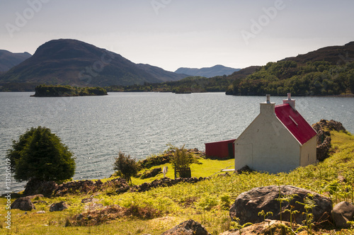 Scotland. Applecros. May 2016. A red roofed croft on the shores of Loch Shieldaig, on the Applecross peninsula in Wester-Ross, Scotland.