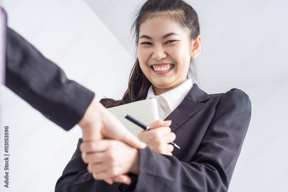 Young asian business woman shaking hands on white background Young asian business woman shaking hands on white background