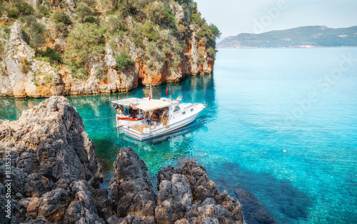 Quadro su tela Fishing boat at mediterranean sea in cosy bay.