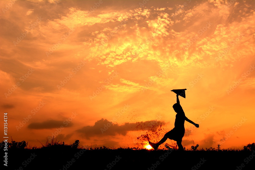 Silhouette boy holding rocket in the sunset. Concept big dream Silhouette boy holding rocket in the sunset. Concept big dream