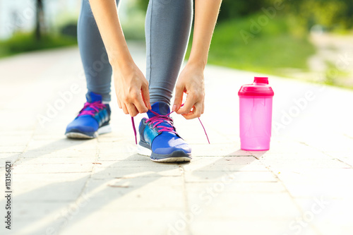 Running shoes - woman tying shoe laces