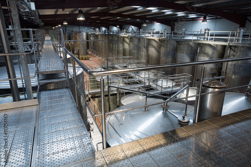 Wine material processing in tanks at plant © JackF