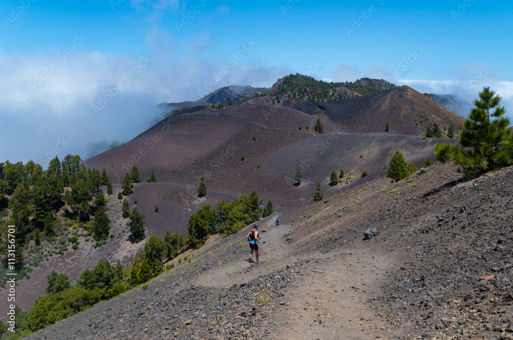 Man and woman running on volcanic trail, La Palma, Spain Man and woman running on volcanic trail, La Palma, Spain
