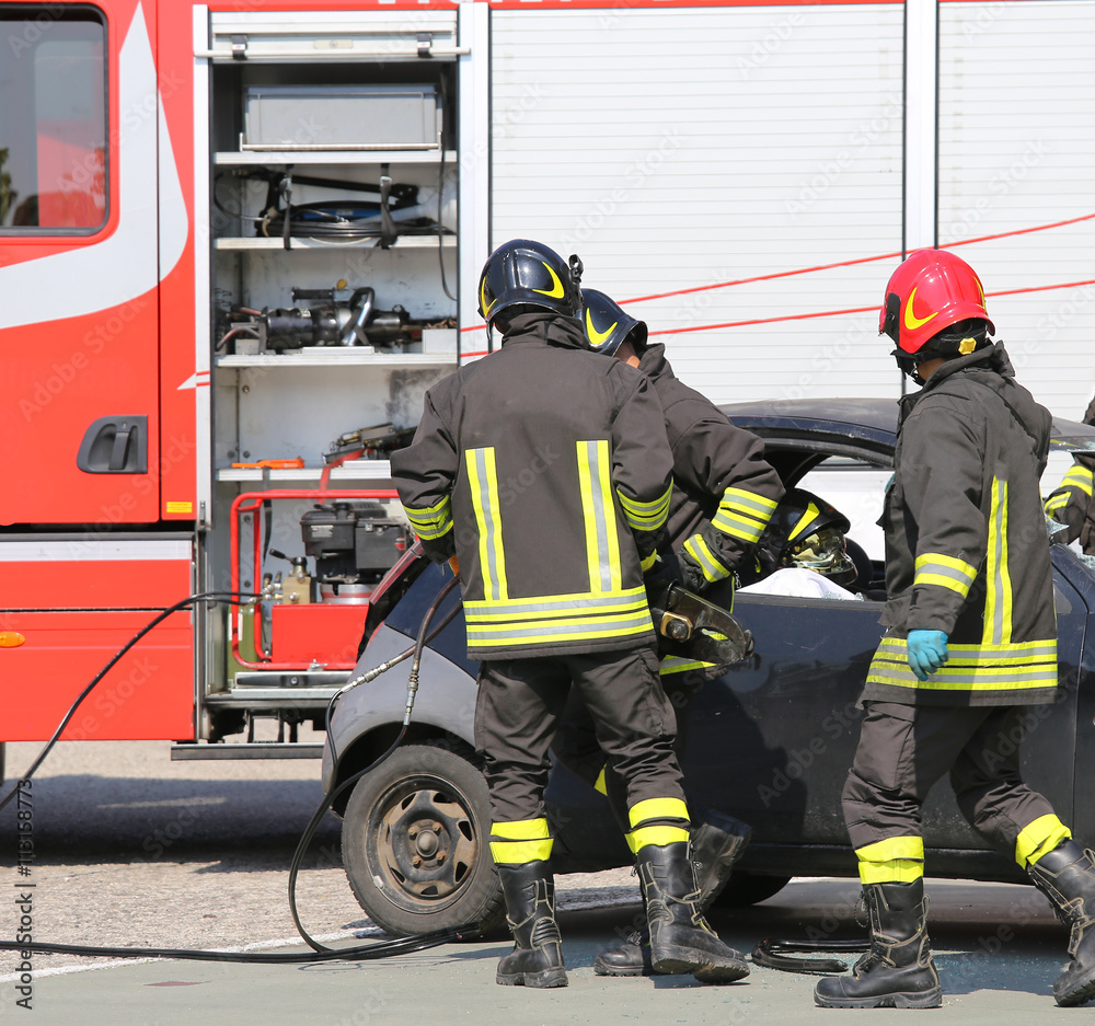 firemen in action during the road accident firemen in action during the road accident