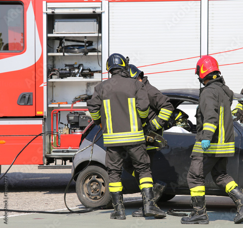firemen in action during the road accident