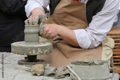 skilled craftsman potter shaping clay to make a vase handmade