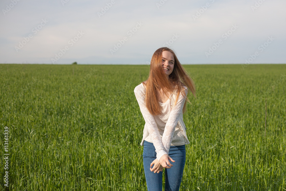 woman with open arms in the green wheat field at the morning woman with open arms in the green wheat field at the morning