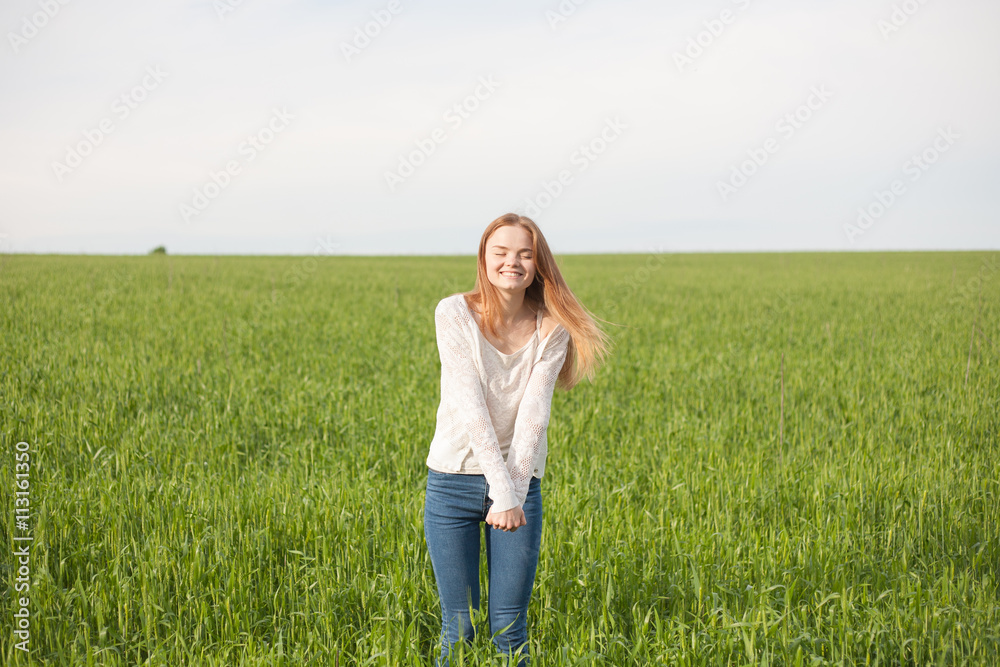 woman with open arms in the green wheat field at the morning woman with open arms in the green wheat field at the morning