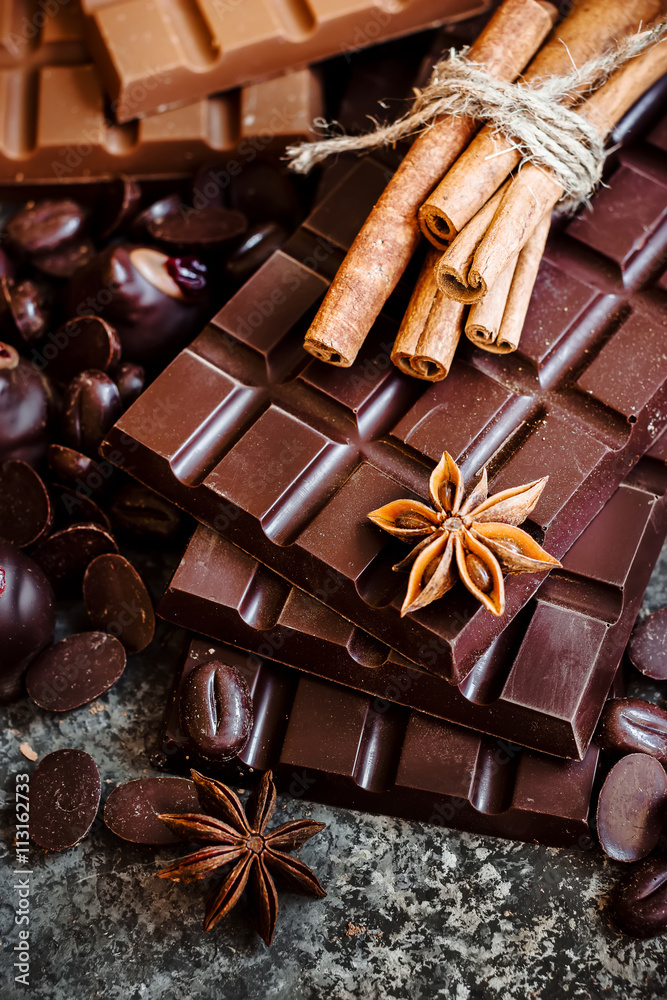 Delicious chocolates and spices on a dark background. Delicious chocolates and spices on a dark background.