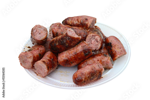 smoked sausages on a plastic plate isolated on white background