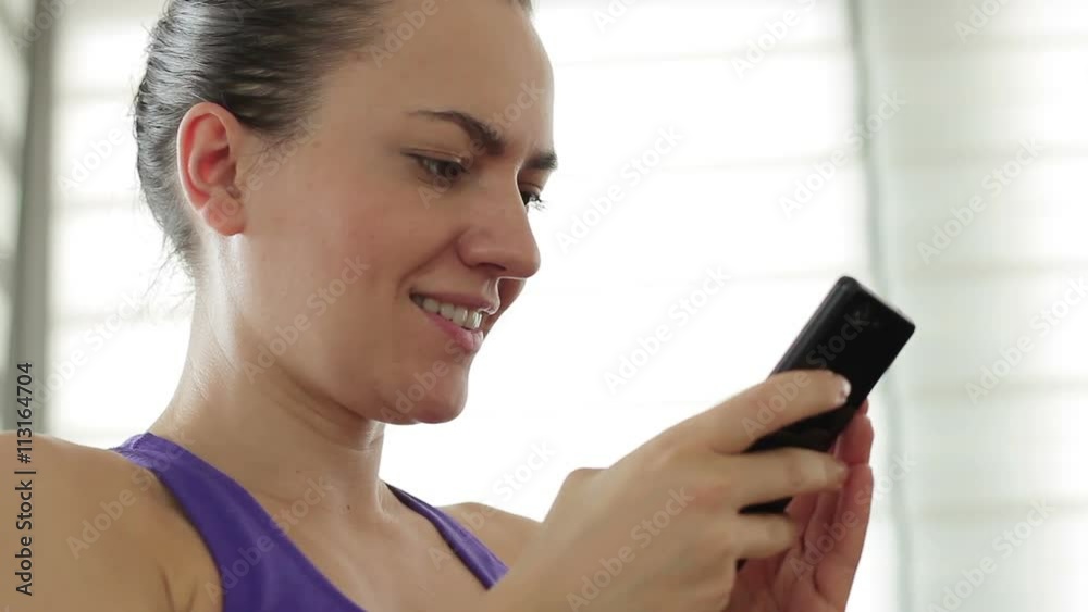 Portrait of woman sending a text message from her cell phone, close up Portrait of woman sending a text message from her cell phone, close up