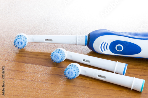 Electronic toothbrush with toothbrush heads on white
