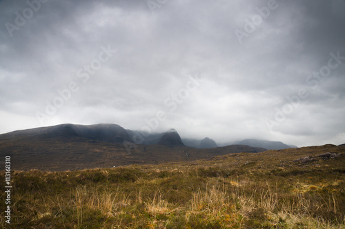 Fototapeta Naklejka Na Ścianę i Meble -  Scotland. Wester-ross. May 2016. Mist and heavy cloud shrouding the tops of Beinn Bhan in Glen Kishorn, Wester-Ross, in the Scottish Highlands.