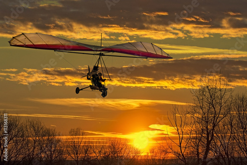 Hang glider fly in the sunset