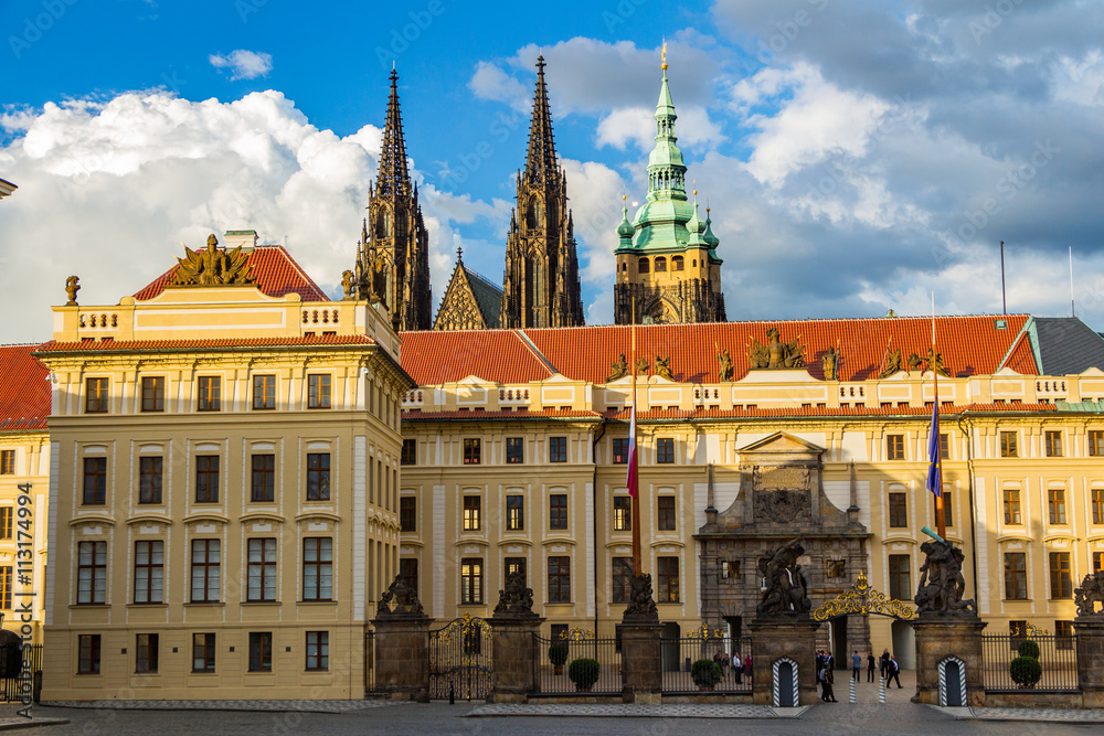 Main gate to the royal area of historical Prague Castle at sunny day, in the background the St Vitus cathedral, Czech Republic