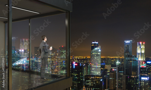 Businessman on balcony at night