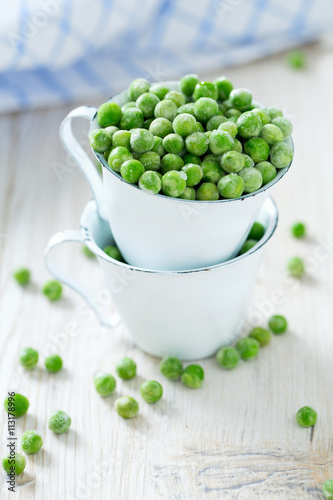 frozem peas on wooden surface photo