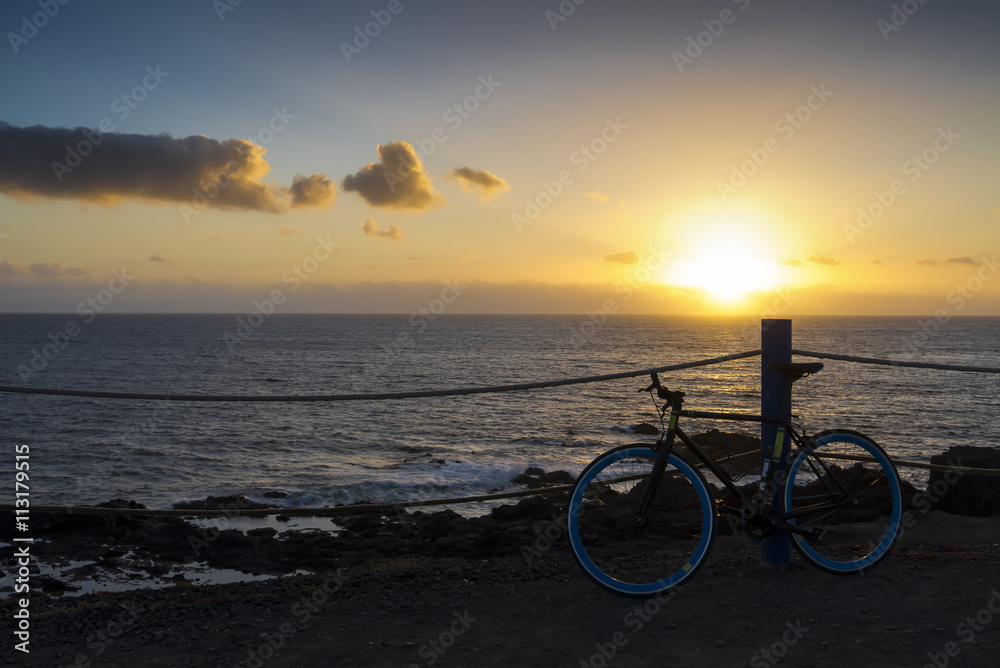 Bicycle sunset cliff ocean.