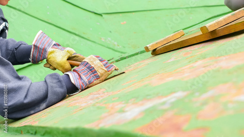 Woman Sitting Next to the Ladder, Scraping Paint