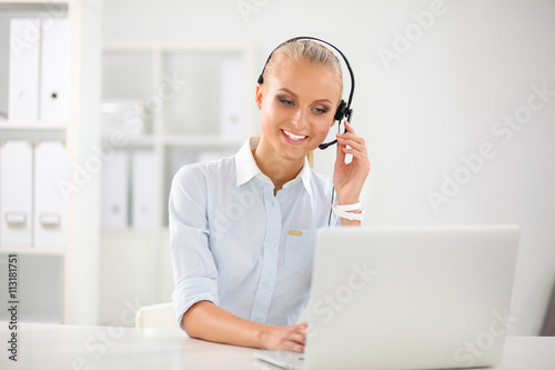 Close-up portrait of a customer service agent sitting at office