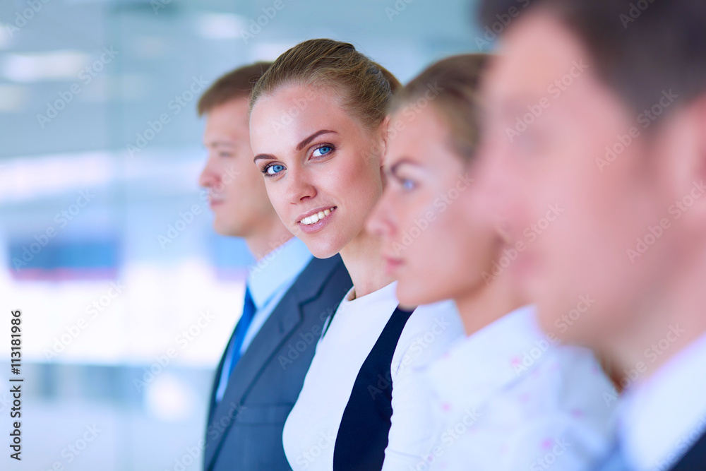 Smiling successful business team standing in office Smiling successful business team standing in office