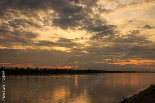Sun and clouds over river