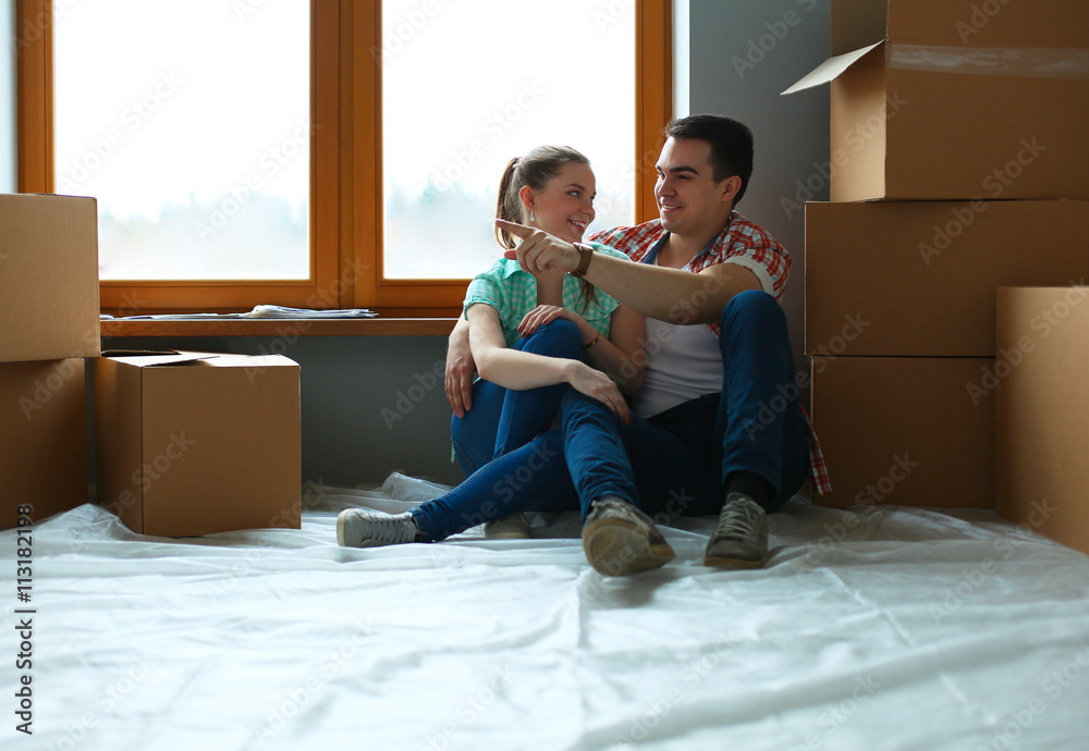 Portrait of young couple moving in new home Portrait of young couple moving in new home