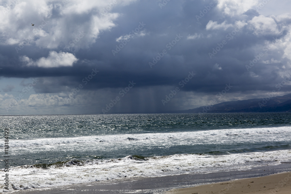 Pacific ocean during a storm. Beach landscape in the U.S. in bad weather. The ocean and waves during strong winds in United States, Santa Monica.