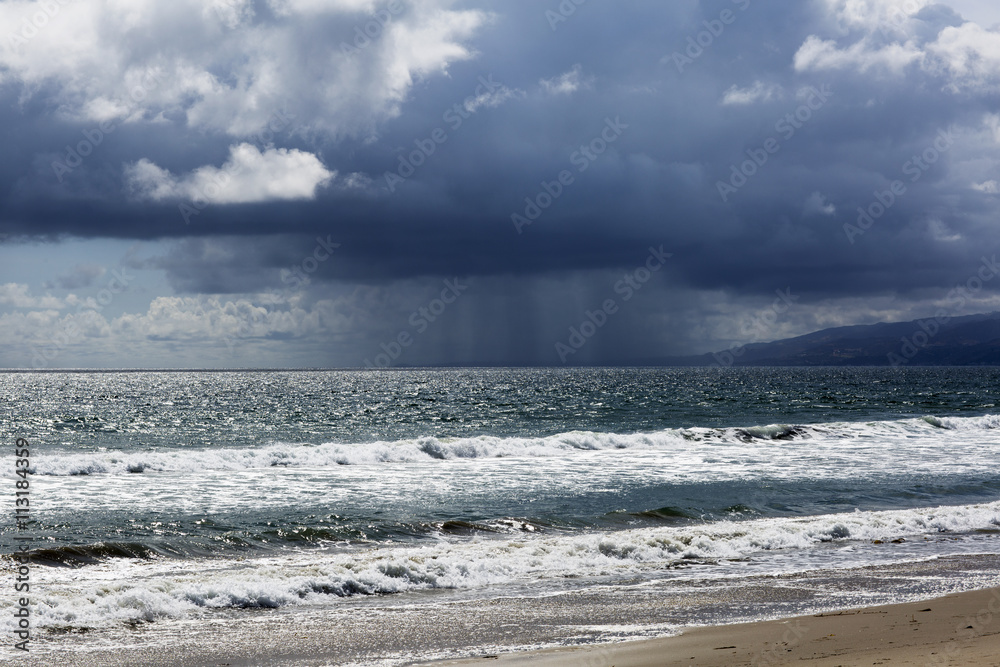 Pacific ocean during a storm. Beach landscape in the U.S. in bad weather. The ocean and waves during strong winds in United States, Santa Monica. Pacific ocean during a storm. Beach landscape in the U.S. in bad weather. The ocean and waves during strong winds in United States, Santa Monica.