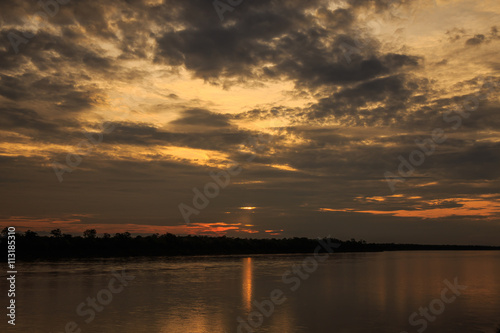 Sun and clouds over river