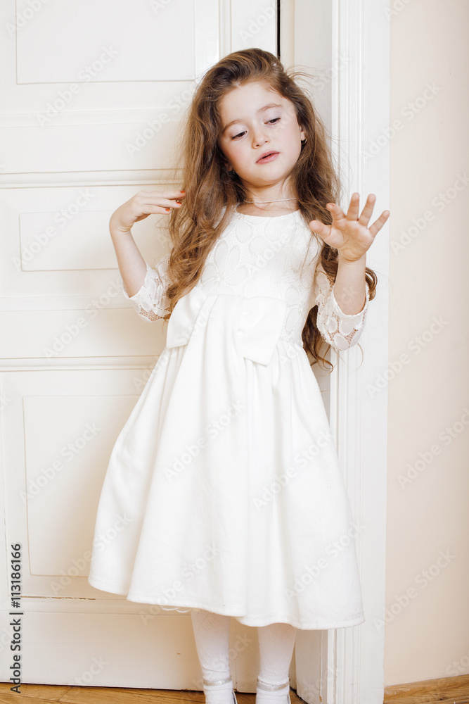 little cute girl at home opening door well dressed in white dress adorable milk fairy teeth Stock Photo Adobe Stock