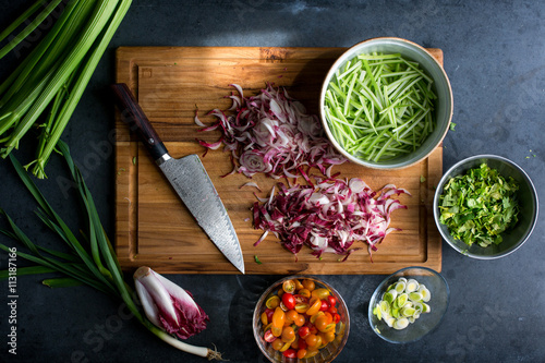 Assorted vegetables chopped on wooden cutting board