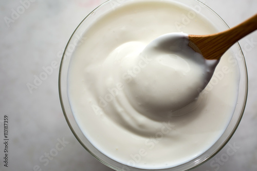 Stirring homemade yoghurt in bowl photo