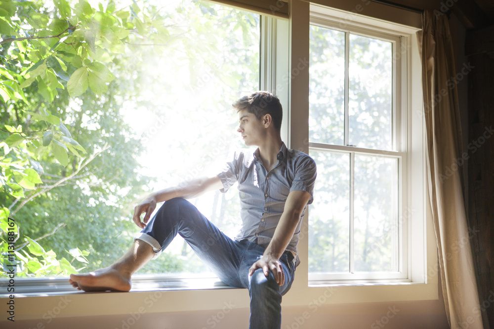 Young man at the window stock photo. Image of casual - 30207172