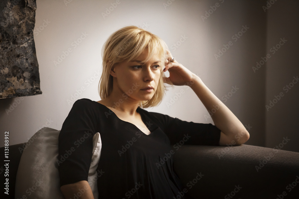 Young woman sitting on sofa Young woman sitting on sofa