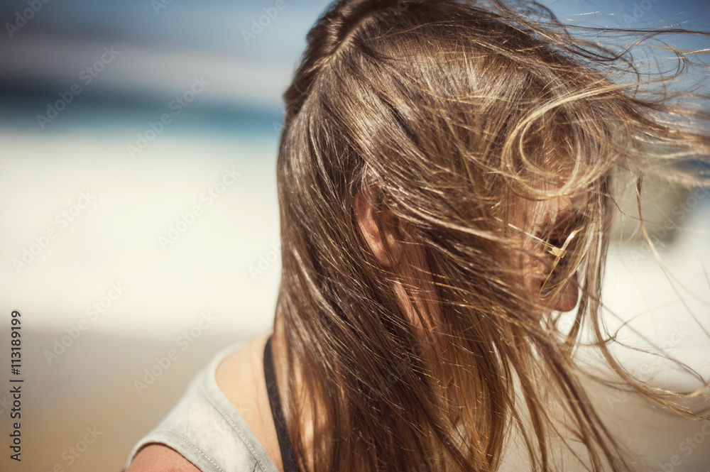 Side-view of woman with tousled hair Side-view of woman with tousled hair