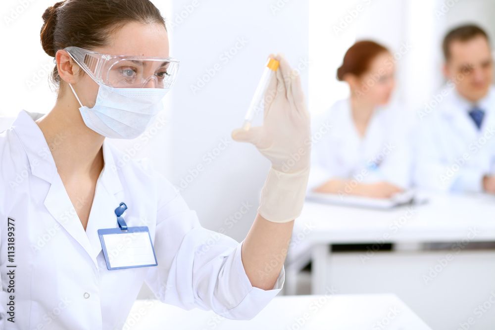 Scientific research team with clear solution in laboratory Scientific research team with clear solution in laboratory