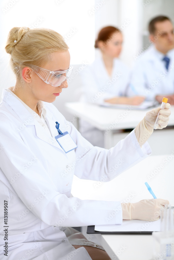 Scientific research team with clear solution in laboratory Scientific research team with clear solution in laboratory