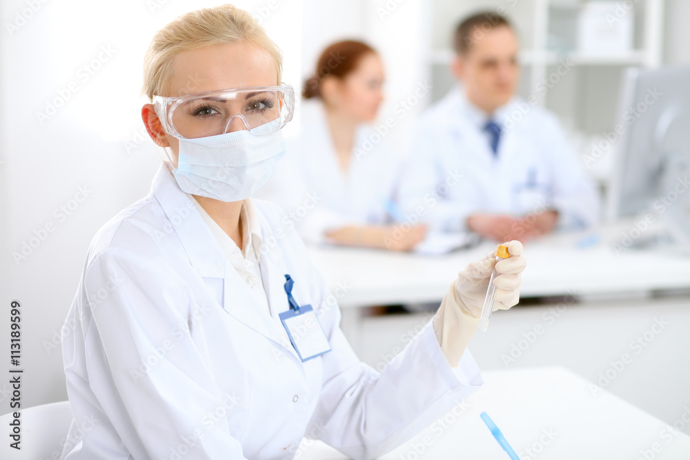 Scientific research team with clear solution in laboratory Scientific research team with clear solution in laboratory