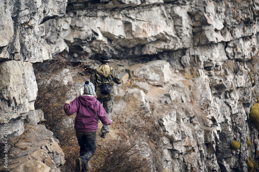 Hikers walking on rocks Hikers walking on rocks
