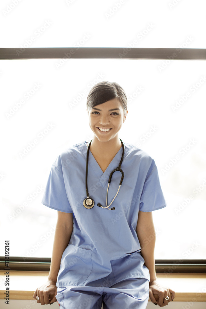 Portrait of young nurse with stethoscope and scrubs Portrait of young nurse with stethoscope and scrubs