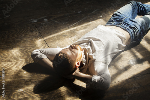 Young man lying on floor
