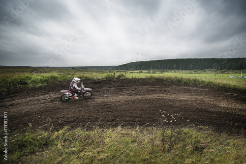 Man motocross riding on dirt road photo