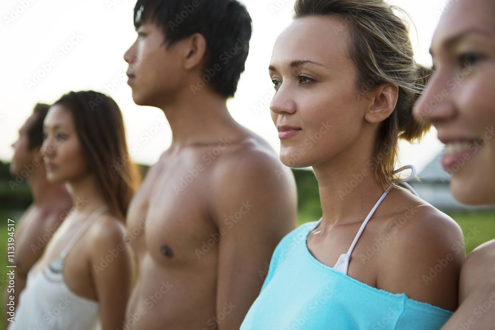 Friends standing in row at beach Friends standing in row at beach