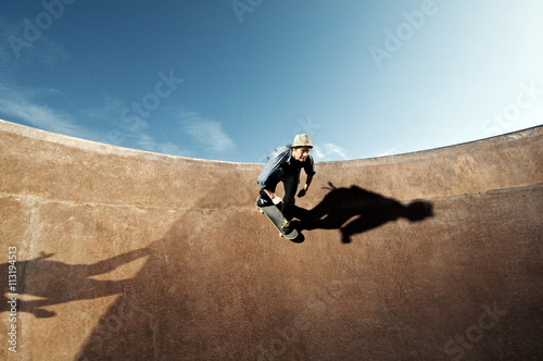 Young man skateboarding on sports ramp