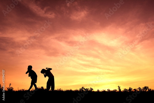 Silhouette children playing at sunset © sawitreelyaon